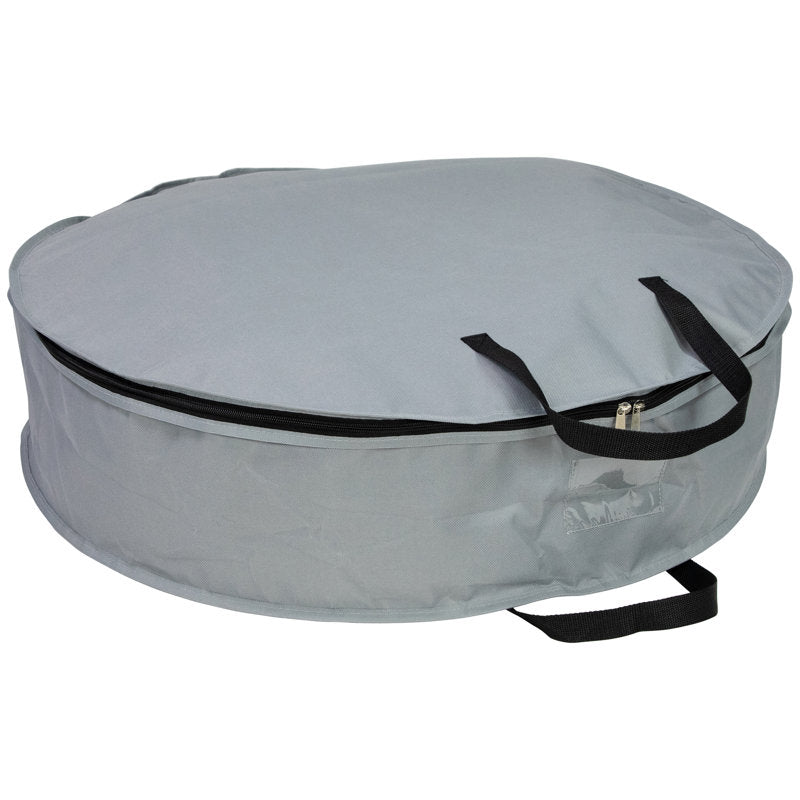 Wreath storage bag protecting a holiday wreath from dust and damage